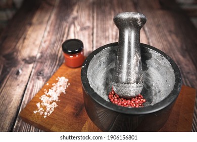 Kitchen mortar with red berries on a wooden board - Powered by Shutterstock