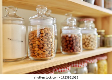 Kitchen Pantry, Wooden Shelves With Jars And Containers With Food, Food Storage. Jars With Vanilla Sugar, Hazelnuts In Almond Pistachios