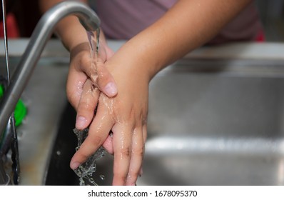 Kitchen Porter Washing Her Hands In  Kitchen