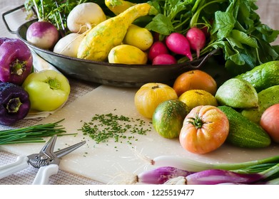 A kitchen scene with snipped chives and freshly washed vegetables.