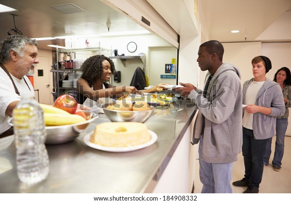 Kitchen Serving Food In\
Homeless Shelter