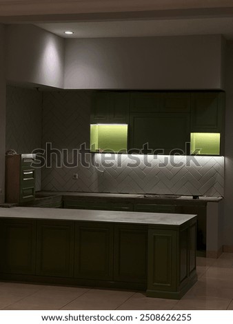 The kitchen set is installed using 18mm blockmin material coated with green duco paint, design interior