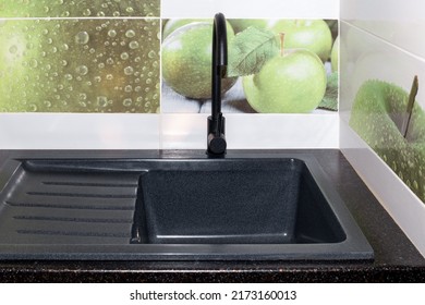 Kitchen Sink And Faucet Installation. The Black Sink And Faucet Are Built Into The Black Countertop. Repair In The House.