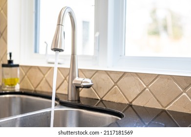 Kitchen Sink With Water Coming Out Of The Facet