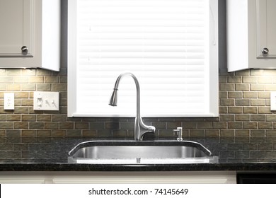 A Kitchen Sink And Window Centered In A Kitchen