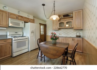 Kitchen In Suburban Home With Oak Wood Cabinetry