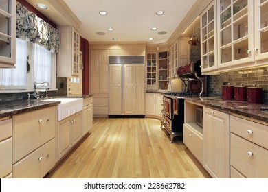 Kitchen In Suburban Home With Oak Wood Cabinetry