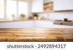 Kitchen table background, wood counter top on blur of white clean abstract home interior with bokeh. used for display or montage your wooden for dining background. table banner