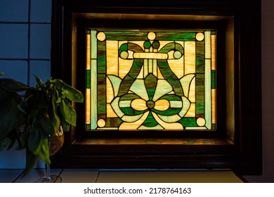 Kitchen Table In Italian Villa Rustic Tuscany Home With Sunlight Light Coming Through Stained Glass Window With Plant In Dark Room