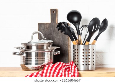 Kitchen table, kitchen utensils, cooking pots at white kitchen. - Powered by Shutterstock