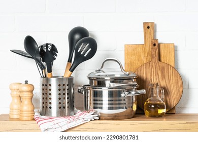 Kitchen table, kitchen utensils, cooking pots at white kitchen. - Shutterstock ID 2290801781