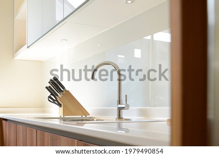 Kitchen tap and knife set in the minimalist kitchen set. 