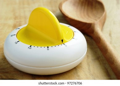 kitchen timer and a wooden spoon on the table