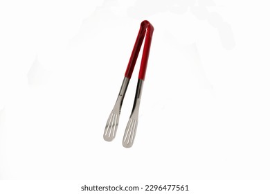 kitchen tongs with a red handle on a white background