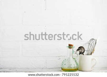 Kitchen tools on a kitchen shelf against a white brick wall. selective focus,