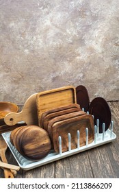 Kitchen tools, utensils and kitchenware on the dish rack. Wooden table, space for text.