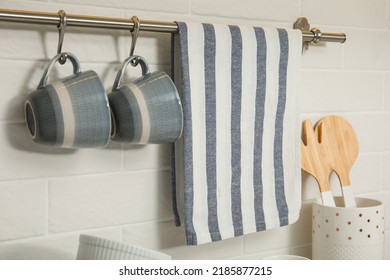 Kitchen Towel And Cups Hanging On Rack Indoors