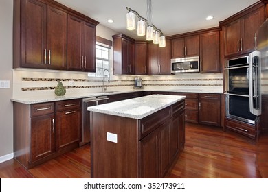 Kitchen In Upscale Home With Cherry Wood Cabinetry