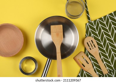 Kitchen utensil on yellow background, top view.