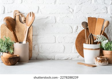 Kitchen utensils background with a blank space for a text and white brick background, home kitchen decor concept with kitchen tools, front view - Shutterstock ID 2278288239