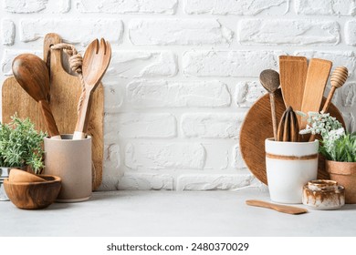 Kitchen utensils background with a blank space for a text and white brick background, home kitchen decor concept with kitchen tools, front view - Powered by Shutterstock