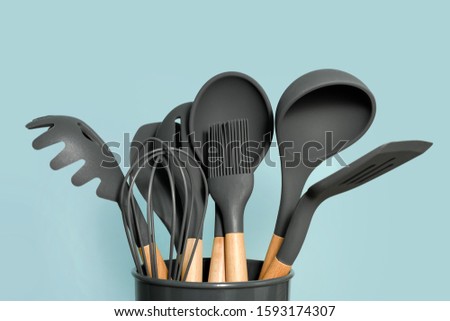Kitchen utensils background with copyspace, home kitchen decor concept, kitchen tools, rubber accessories in container. Restaurant, cooking, culinary, kitchen theme. Silicone spatulas and brushes
