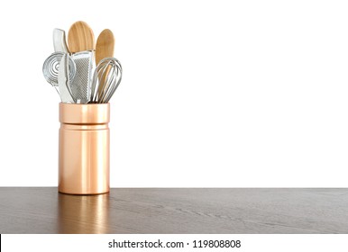 Kitchen Utensils In A Ceramic Container On White Background