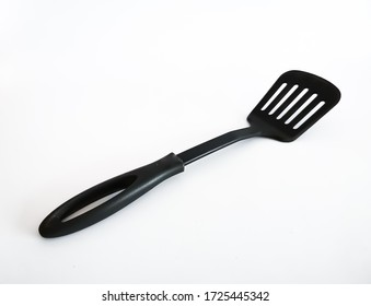 Kitchen Utensils. Close-up Of A Black Plastic Kitchen Spatula On A White Background.