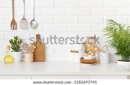 Kitchen utensils, cooking ingredients and kitchenware on white counter table