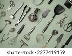Kitchen utensils or cooking tools on green background, top view, flat lay. Kitchenware collection with copy space. Cooking background.