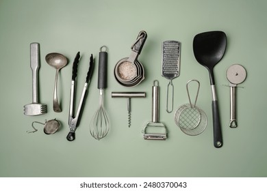 Kitchen utensils or cooking tools on green background, top view, flat lay. Kitchenware collection with copy space. Cooking background. - Powered by Shutterstock