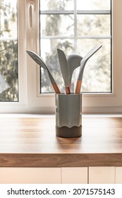 Kitchen Utensils In Cup On A Light Background. Wooden Table Top. French Window. Kitchen Utensils.