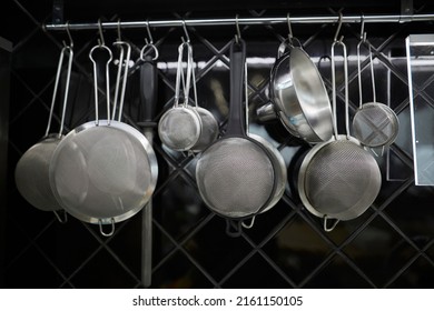 kitchen utensils hanging on the kitchen wall. kitchen metal utensils hang on the wall in the kitchen.