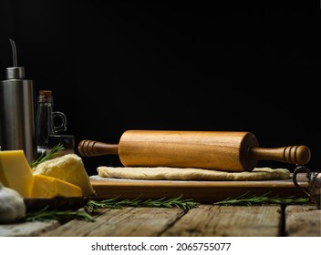 Kitchen Utensils And Ingredients For Making Dough On A Kitchen Wooden Table. Black Background. Close-up. There Are No People In The Photo. There Is An Empty Space For Insertion. Restaurant, Bakery.