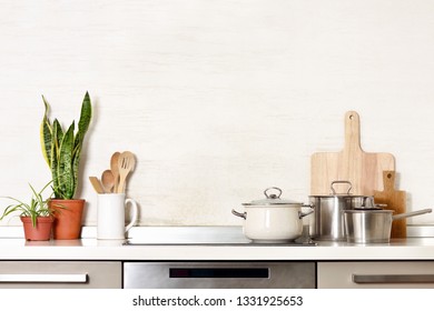 Kitchen utensils on a modern home kitchen table top, front view background with blank space for a text