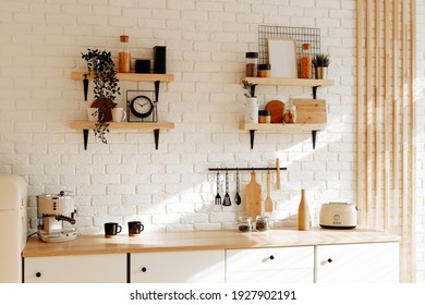 Kitchen utensils and utensils on a wooden countertop. Stylish kitchen interior in white and beige tones, spring background - Shutterstock ID 1927902191