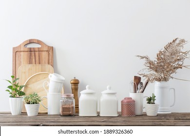 kitchen utensils on  wooden table in  white kitchen - Shutterstock ID 1889326360