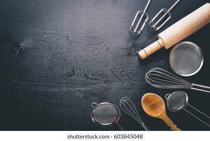 Kitchen Utensils. Preparation For Baking. Wooden Photo On A Black Background. Top View. Free Space.