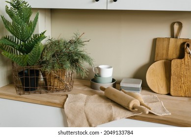 Kitchen Utensils In The Scandinavian Kitchen: Christmas Tree In A Pot, Spruce Branches, Wooden Cutting Boards, Rolling Pin And Towel