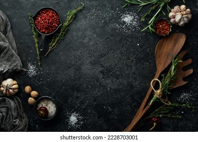 Kitchen utensils, spices and herbs on a stone background. Cooking concept. Top view. Free space for your text. - Shutterstock ID 2228703001