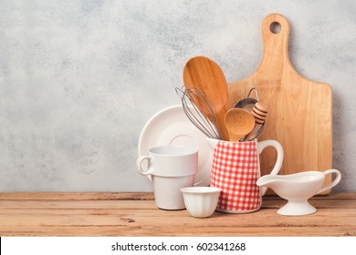 Kitchen Utensils And Tableware On Wooden Table Over Rustic Background With Copy Space