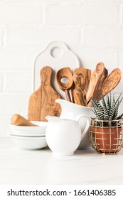 Kitchen utensils,tools  and dishware on on the background white  brick wall.Interior, modern kitchen space in bright colors.Blank space for a text, front view