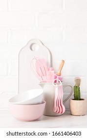 Kitchen utensils,tools  and dishware on on the background white  brick wall.Interior, modern kitchen space in bright colors.Blank space for a text, front view