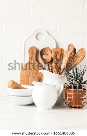 Kitchen utensils,tools  and dishware on on the background white  brick wall.Interior, modern kitchen space in bright colors.Blank space for a text, front view