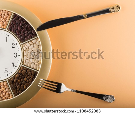 Kitchen wall clock, fork and knife. Top view with space for text