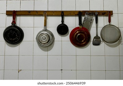 Kitchen wall shelves for hanging pots, pans, aprons and other utensils. - Powered by Shutterstock