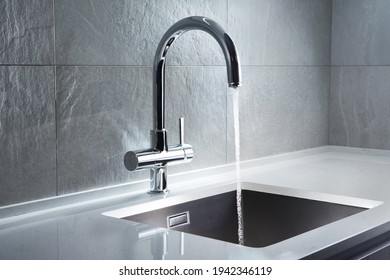 Kitchen water mixer. Water tap made of chrome material - Shutterstock ID 1942346119
