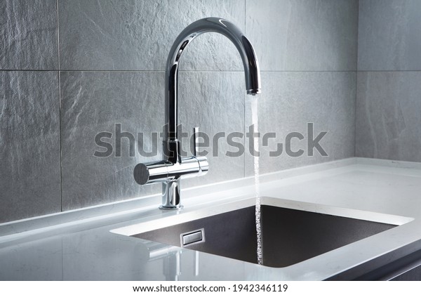 Kitchen\
water mixer. Water tap made of chrome\
material