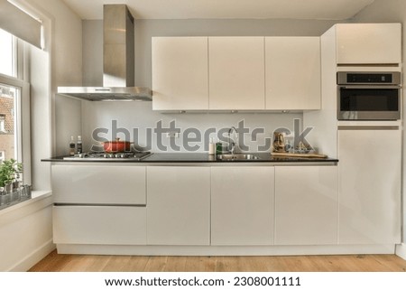 a kitchen with white cabinets and black counter tops on the island in front of the sink is an oven, microwave and dishwasher