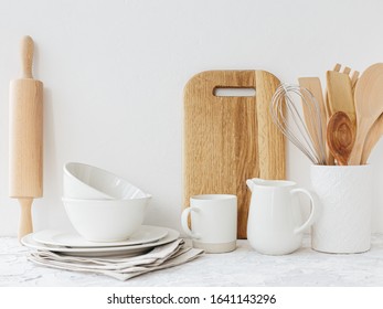 Kitchen white tableware wooden utensils on the table. Eco friendly kitchen concept. Minimalism kitchen scandinavian style. Copy space fot text